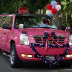 Carolina Luxury Transportation Group pink limousine in the Waxhaw Parade for fourth of July
