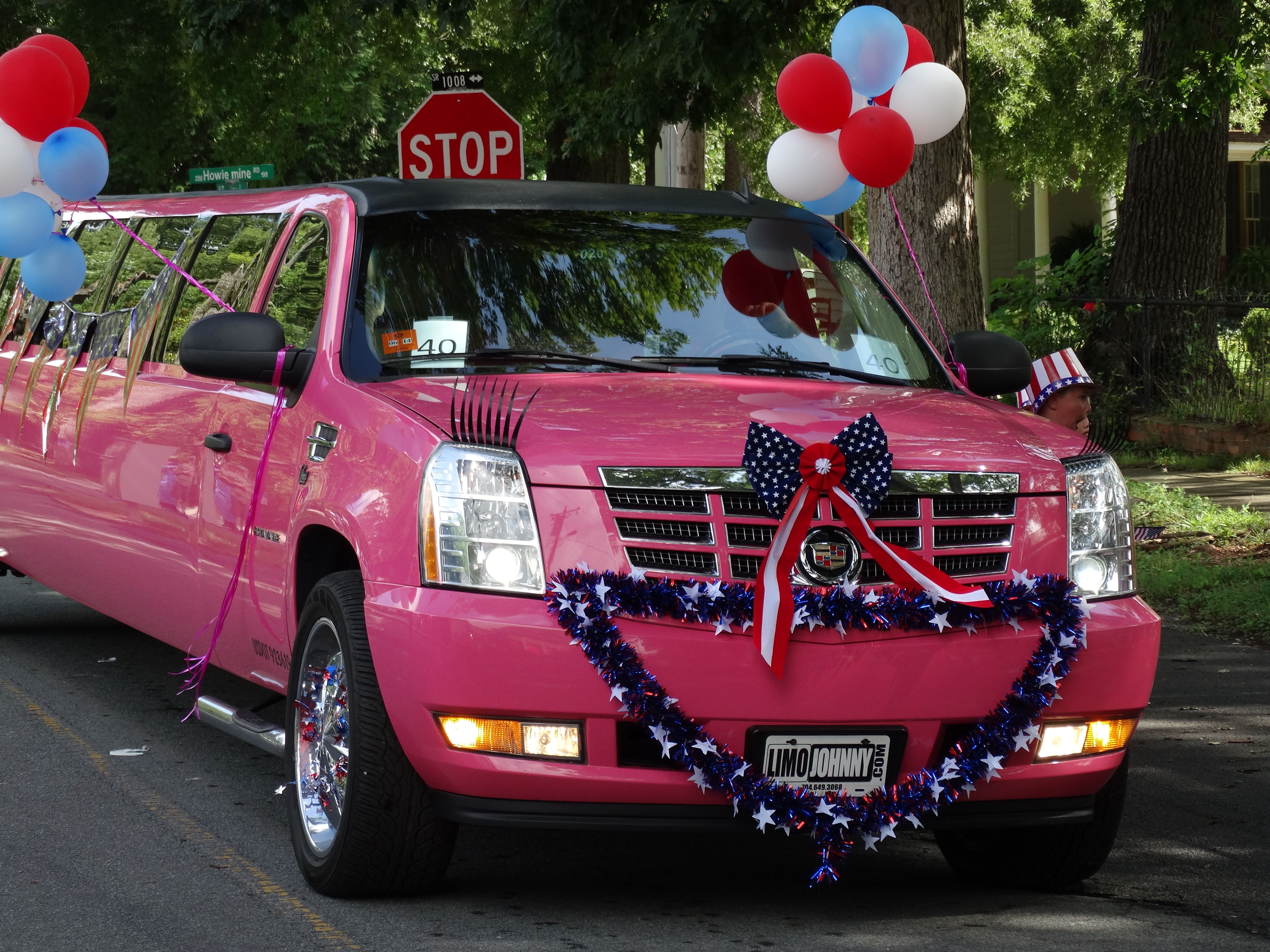 Carolina Luxury Transportation Group pink limousine in the Waxhaw Parade for fourth of July