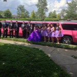 Quinceañera in purple dress atanding near Johnny B's Pink Limo in Charlotte NC