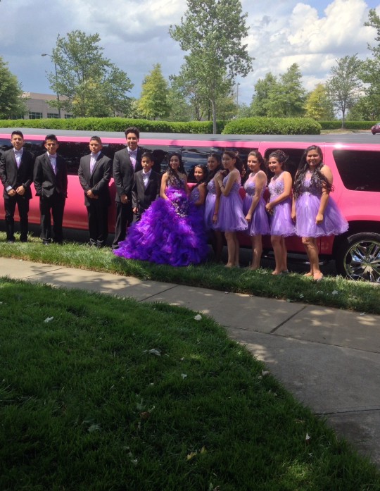 Quinceañera in purple dress atanding near Johnny B's Pink Limo in Charlotte NC