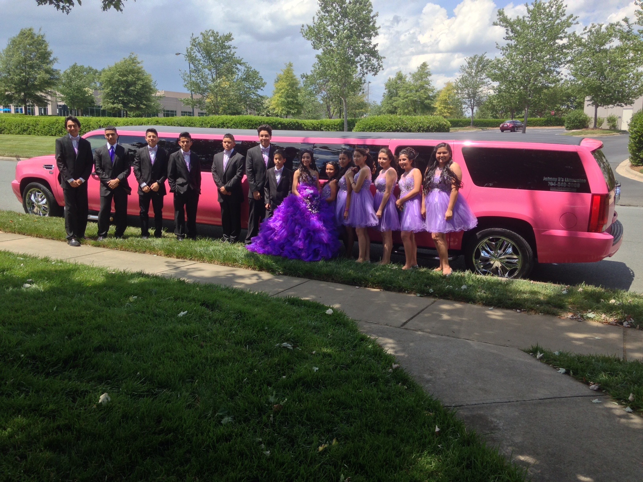 Quinceañera in purple dress atanding near Johnny B's Pink Limo in Charlotte NC